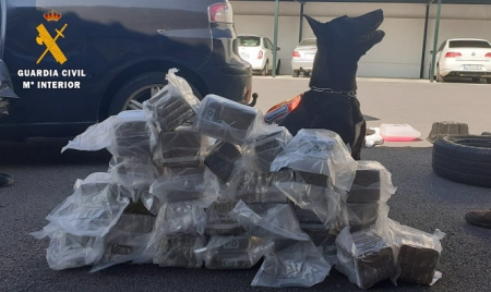 Perro de la Guardia Civil ante la droga incautada (GUARDIA CIVIL)