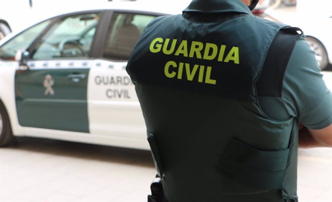 Un agente de la Guardia Civil, de espaldas, junto a un vehículo oficial. (GUARDIA CIVIL)